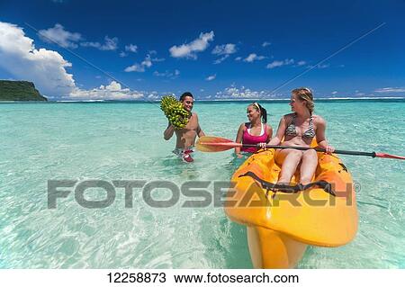 Stock Image - Tourists paddling in clear waters off Upolu Island; Upulu, Samoa. Fotosearch