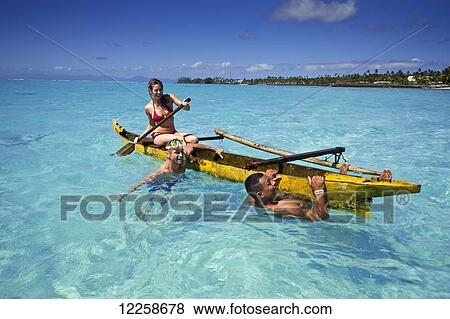 Stock Photo - Tourists paddling in clear waters; Upulu Island, Samoa. Fotosearch