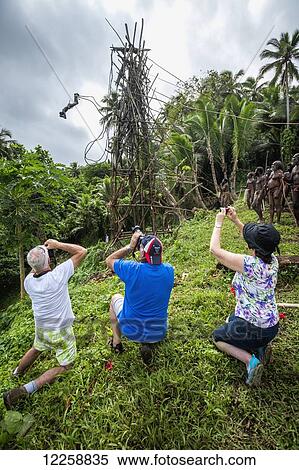 Stock Photography - Tourists photographing the land diving ceremony; Pentecost Island, Vanuatu. Fotosearch