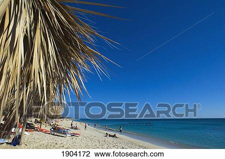 Tourists Relaxing At Ancon Beach, Trinidad, Cuba View Large Photo Image Stock Image - Tourists Relaxing At Ancon Beach, Trinidad, Cuba. Fotosearch