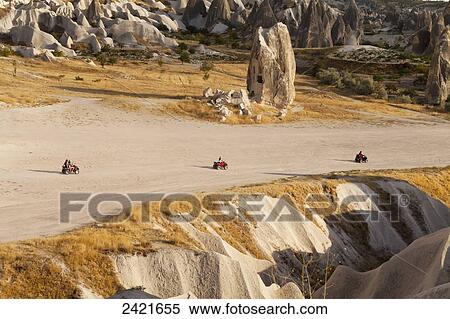 Tourists ride on all-terrain vehicles down a road in Rose Valley; Cappadocia, Turkey View Large Photo Image Stock Photography - Tourists ride on all-terrain vehicles down a road in Rose Valley; Cappadocia, Turkey. Fotosearch