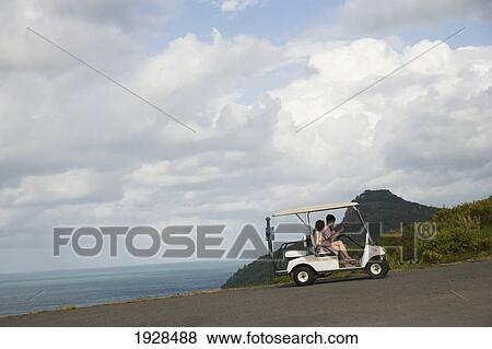 Stock Photo - Tourists Riding In Golf Cart On Road On Whitsunday Islands, Queensland, Australia. Fotosearch