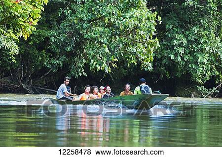 Stock Photo - Tourists river boating at Ulu Temburong National Park; Brunei. Fotosearch