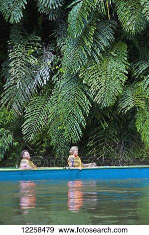 Stock Photo - Tourists river boating at Ulu Temburong National Park; Brunei. Fotosearch