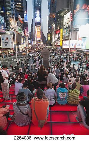 Tourists Seated In The Stands In Duffy Square Area Of Times Square; New York City New York Usa View Large Photo Image Stock Photograph - Tourists Seated In The Stands In Duffy Square Area Of Times Square; New York City New York Usa. Fotosearch
