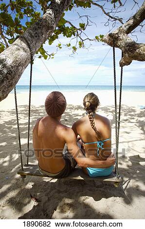 Tourists Sitting On Swing At Red Frog Beach View Large Photo Image Stock Image - Tourists Sitting On Swing At Red Frog Beach. Fotosearch