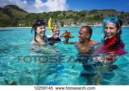 Tourists snorkelling off Atauro Island; Atauro Island, Timor-Leste View Large Photo Image Stock Photography - Tourists snorkelling off Atauro Island; Atauro Island, Timor-Leste. Fotosearch