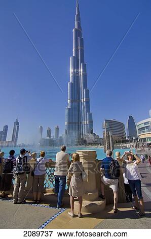 Stock Photo - Tourists Standing By Railing At Burj Khalifa, Dubai, Uae. Fotosearch
