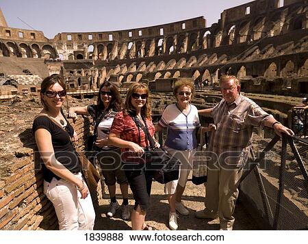 Tourists Standing In The Flavian Amphitheater (Colosseum); Rome, Italy View Large Photo Image Stock Photo - Tourists Standing In The Flavian Amphitheater (Colosseum); Rome, Italy. Fotosearch