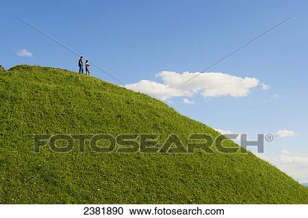 Stock Image - Tourists standing on top of Krakus Mound; Krakow, Poland. Fotosearch