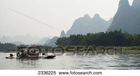 Stock Photography - Tourists Take A Boat Ride Down The River Li; Guilin, Guangxi, China. Fotosearch
