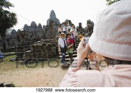 Stock Photo - Tourists Taking Photo At Temples Of Angkor, Siem Reap, Cambodia. Fotosearch