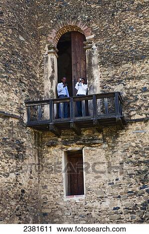 Stock Image - Tourists taking pictures on a balcony at the seventeenth century palace of King Fasilides; Gondar, Ethiopia. Fotosearch