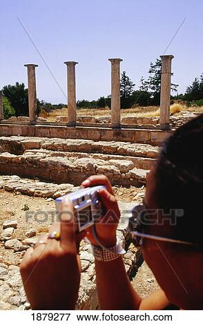 Stock Photo - Tourists Taking Pictures With A Digital Camera At Sanctuary Of Apollon Ylatis. Fotosearch