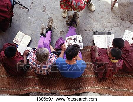 Stock Photo - Tourists Teaching Young Monks English In Phuktal Monastery. Fotosearch