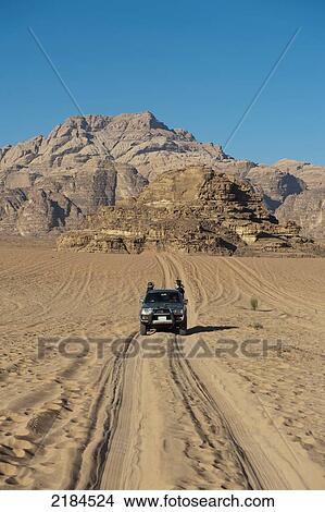 Picture - Tourists Travelling By 4X4 Jeep In Wadi Rum, Jordan, Middle East. Fotosearch