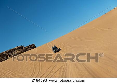 Stock Image - Tourists Travelling By 4X4 Jeep In Wadi Rum, Jordan, Middle East. Fotosearch