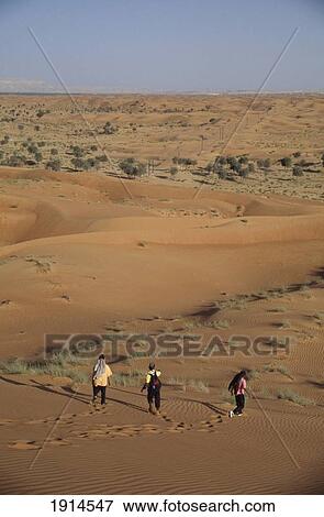 Tourists Trekking Through The Desert View Large Photo Image Stock Photo - Tourists Trekking Through The Desert. Fotosearch