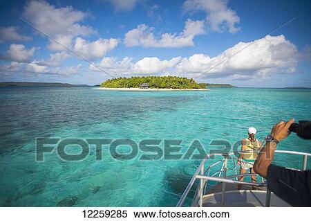 Tourists view Mounu Island from a boat; Vavau, Tonga View Large Photo Image Stock Photography - Tourists view Mounu Island from a boat; Vavau, Tonga. Fotosearch