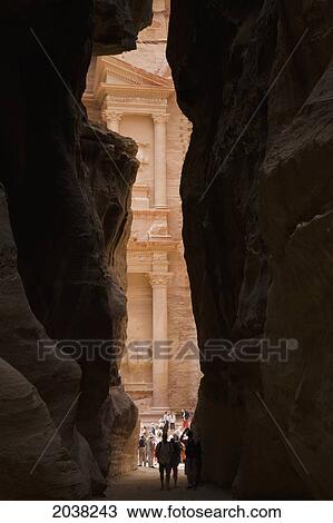 Stock Image - Tourists Visit The Treasury In The Nabatean City; Petra Jordan. Fotosearch