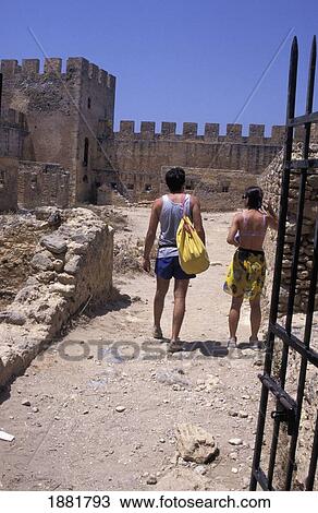 Stock Image - Tourists Visiting Ruins Of Castle. Fotosearch