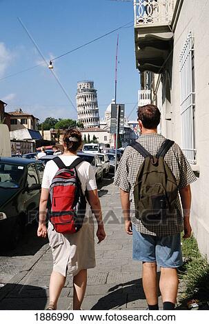 Stock Image - Tourists Walking Along Via Card. With Leaning Tower Of Pisa In The Distance. Fotosearch