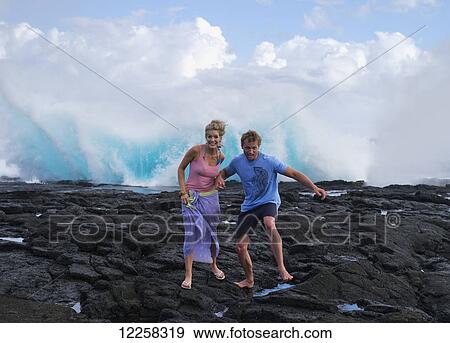 Tourists walking amongst the blowholes; Savaii Island, Samoa View Large Photo Image Stock Photo - Tourists walking amongst the blowholes; Savaii Island, Samoa. Fotosearch