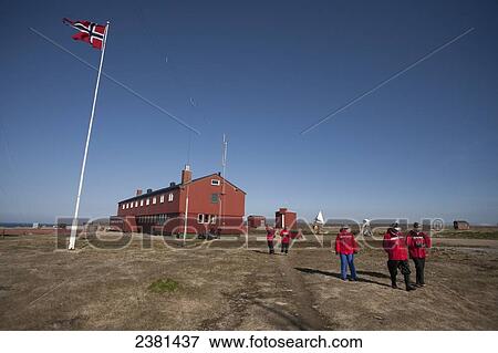Stock Photo - Tourists walking around an island; Svalbard, Norway. Fotosearch
