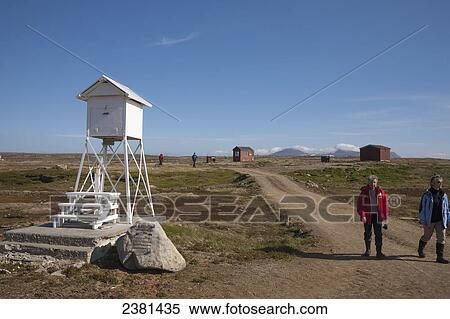 Stock Photography - Tourists walking around Svalbard; Svalbard, Norway. Fotosearch