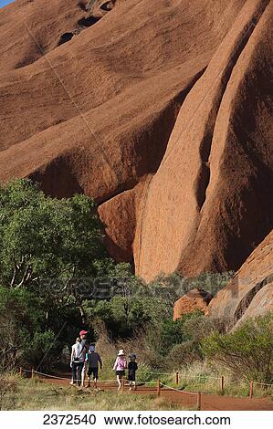 Tourists walking around Uluru, formerly known as Ayers Rock; Northern Territory, Australia View Large Photo Image Stock Image - Tourists walking around Uluru, formerly known as Ayers Rock; Northern Territory, Australia. Fotosearch