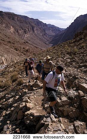Stock Photo - Tourists Walking / Trekking, High Atlas Mountains, Todra Gorge, Morocco. Fotosearch