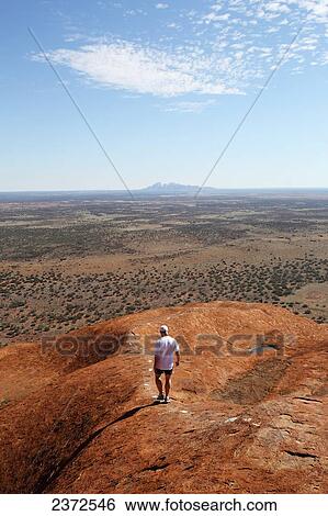 Tourists walking up Uluru, formerly known as Ayers Rock; Northern Territory, Australia View Large Photo Image Stock Photograph - Tourists walking up Uluru, formerly known as Ayers Rock; Northern Territory, Australia. Fotosearch