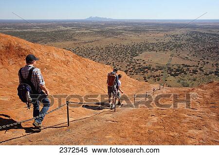 Tourists walking up Uluru, formerly known as Ayers Rock; Northern Territory, Australia View Large Photo Image Stock Photography - Tourists walking up Uluru, formerly known as Ayers Rock; Northern Territory, Australia. Fotosearch