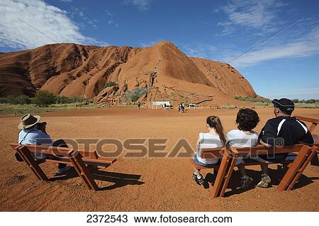 Tourists watching people climb Uluru, formerly known as Ayers Rock; Northern Territory, Australia View Large Photo Image Stock Image - Tourists watching people climb Uluru, formerly known as Ayers Rock; Northern Territory, Australia. Fotosearch