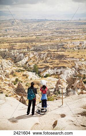 Tourists with a view from the top of Uchisar Castle; Uchisar, Cappadocia, Turkey View Large Photo Image Picture - Tourists with a view from the top of Uchisar Castle; Uchisar, Cappadocia, Turkey. Fotosearch