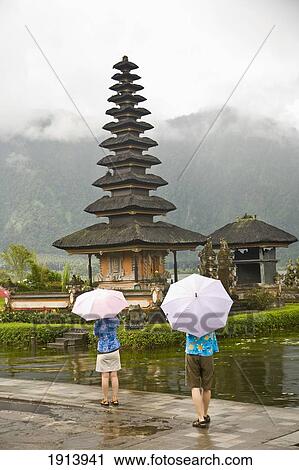 Tourists With Umbrellas At Temple View Large Photo Image Stock Image - Tourists With Umbrellas At Temple. Fotosearch