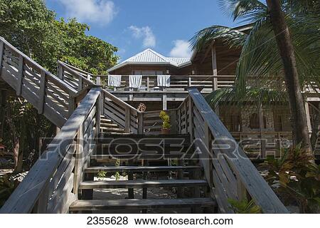 Stock Photo - Towels Dry Over A Railing And Wooden Steps At A Resort; Honduras. Fotosearch