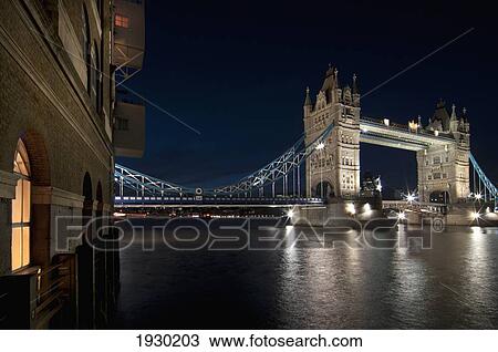 Stock Image - Tower Bridge And Shad Thames at nighttime; London, England. Fotosearch