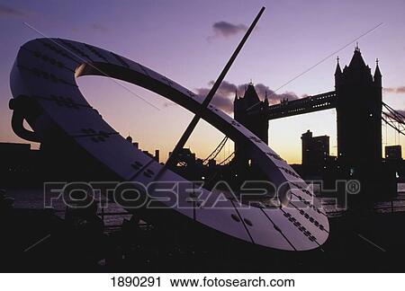 Stock Image - Tower Bridge And Sun Dial At Dusk. Fotosearch