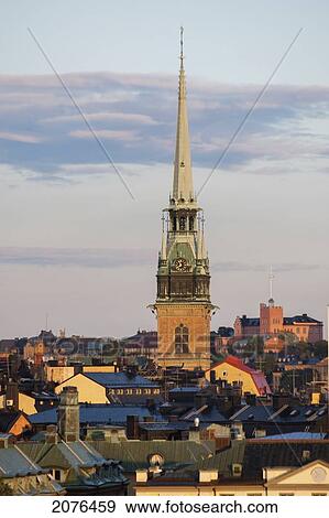 Stock Photo - Tower Of A Church Building Rising Above Rooftops; Stockholm Sweden. Fotosearch