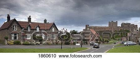 Stock Image - Town With Bamburgh Castle In Background, Bamburgh, Northumberland, England. Fotosearch