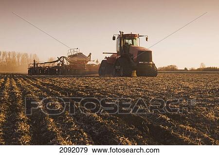 Tractor And Air Till Seeder Planting Grain; Lorette Manitoba Canada View Large Photo Image Stock Photo - Tractor And Air Till Seeder Planting Grain; Lorette Manitoba Canada. Fotosearch
