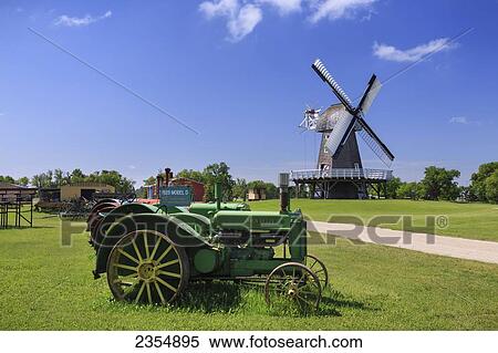 Stock Photography - Tractors And Windmill In Mennonite Heritage Village; Steinbach, Manitoba, Canada. Fotosearch
