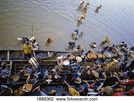 Stock Image - Traders Selling To Passengers On River Niger. Fotosearch
