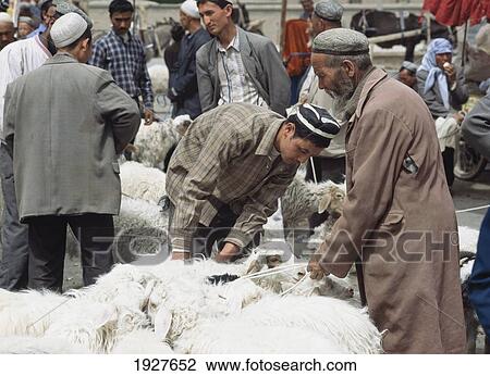 Stock Image - Traders With Sheep At Market. Fotosearch