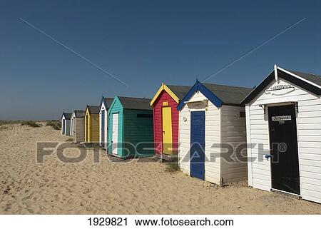 Traditional beach huts in the sand dunes at Southwold, Suffolk, UK View Large Photo Image Stock Image - Traditional beach huts in the sand dunes at Southwold, Suffolk, UK. Fotosearch