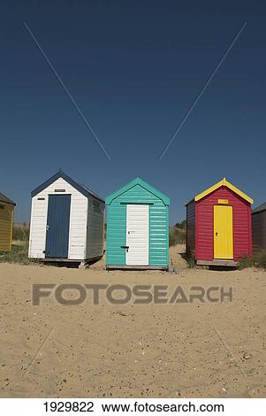 Traditional beach huts in the sand dunes at Southwold, Suffolk, UK View Large Photo Image Stock Image - Traditional beach huts in the sand dunes at Southwold, Suffolk, UK. Fotosearch