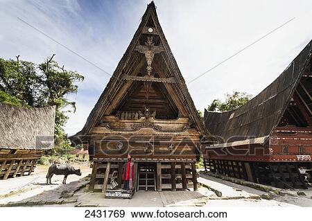 Stock Photo - Traditional boat-shaped Toba Batak houses (jabu) at Huta Bolon Museum in Simanindo village on Samosir Island, Lake Toba, North Sumatra, Indonesia. Fotosearch