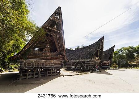 Stock Photograph - Traditional boat-shaped Toba Batak houses (jabu) at Huta Bolon Museum in Simanindo village on Samosir Island, Lake Toba, North Sumatra, Indonesia. Fotosearch