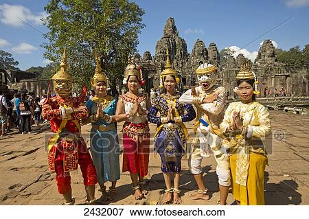 Traditional dancers in front of 12th century Bayon Temple which is the central temple in Angkor Thom, located north of Angkor Wat; Siem Reap, Cambodia View Large Photo Image Stock Photo - Traditional dancers in front of 12th century Bayon Temple which is the central temple in Angkor Thom, located north of Angkor Wat; Siem Reap, Cambodia. Fotosearch